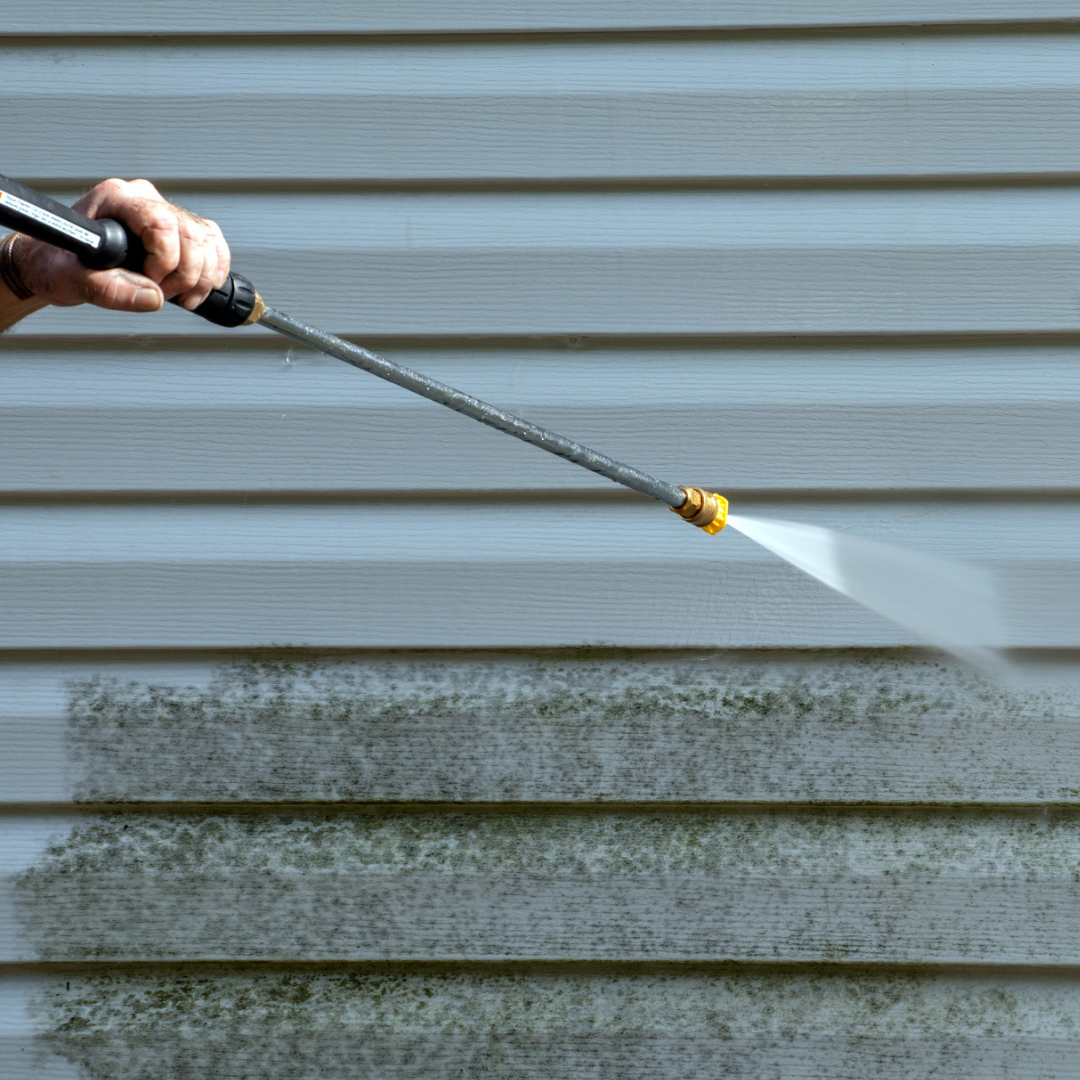 Pressure washing concrete showing dramatic before-and-after stripe